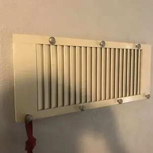 Clever. Took an old shutter turned it sideways and added some drawer pulls to make a coat hanger.