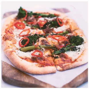 a pizza with broccoli