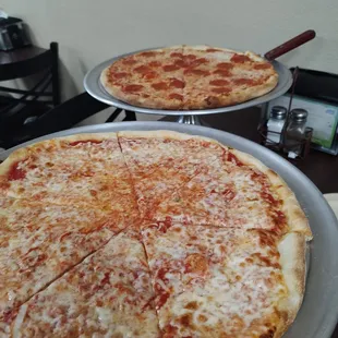 two pizzas on pans