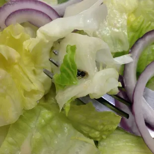 a salad with onions and lettuce