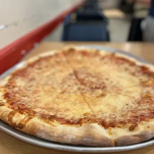 a cheese pizza on a pan