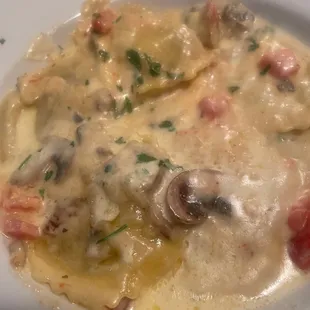 Portabella mushroom ravioli in Alfredo sauce with tomatoes