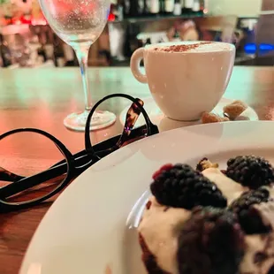 a plate of dessert and a glass of wine
