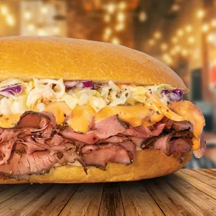 a roast beef sandwich with cheese and coleslaw