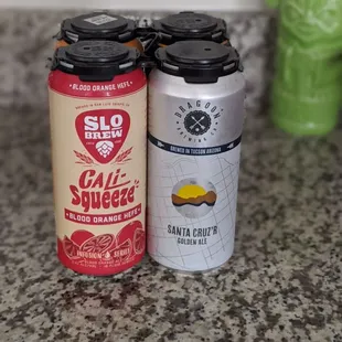 two cans of soda on a counter