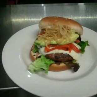 Cali burger. House ground beef with roasted red peppers pepper Jack cheese field greens crispy shallots and red pepper aioli