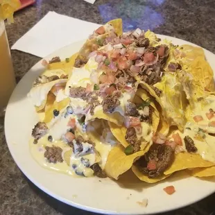 Fully loaded tri tip nachos $11.75 and a blue moon for happy hr $5.00