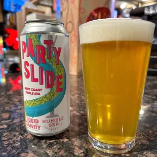 a glass of beer and a can of party slide