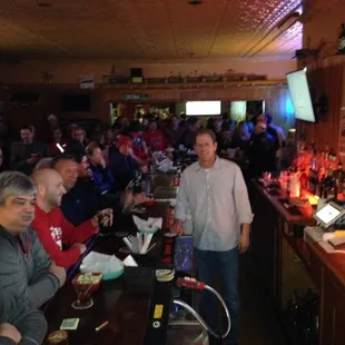 a group of people sitting at a bar