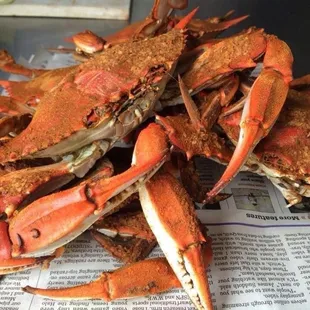 a pile of crabs on a newspaper