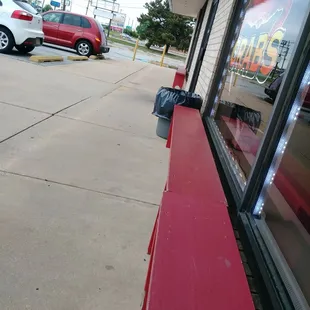 Outside benches. Watch the traffic go by as you wait.