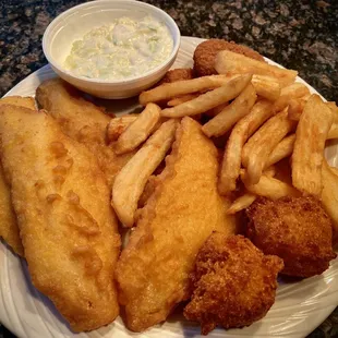 Four piece Fish &amp; Chips, with two crab cakes, two hush puppies, and a side of cole slaw.