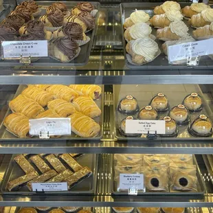 a variety of pastries in a display case