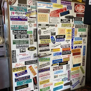 a refrigerator covered in stickers