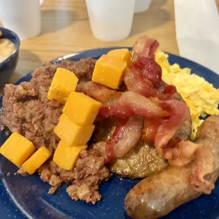From the breakfast buffet bacon, sausage, sausage patty, eggs, cheese, and corn beef hash.