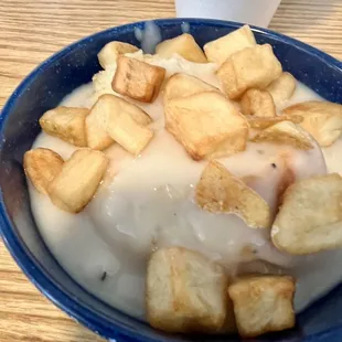 Sausage gravy over a biscuit with some home fries