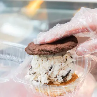 a person putting a cookie in a container