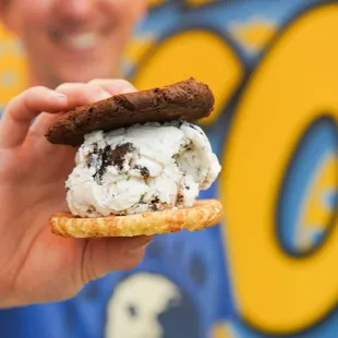 a man holding an ice cream sandwich