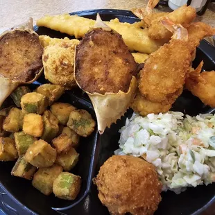 Deluxe Seafood Platter: two fish fillets, six shrimp, two seafood stuffed crab shells with your choice of two sides and hush puppies.