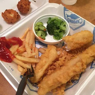 a tray of fish and fries and broccoli