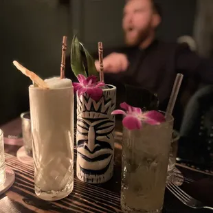 a man sitting at a table with drinks