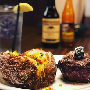 A loaded baked potato with a tender steak