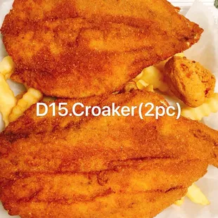 two pieces of fried fish with macaroni and cheese