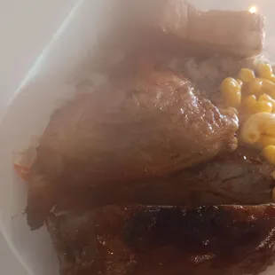 Close up of ribs Mac and cheese baked chicken etc