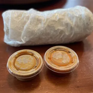 Breakfast Burrito wrapped nicely in paper and plastic wrap.  Mild and spicy salsas.