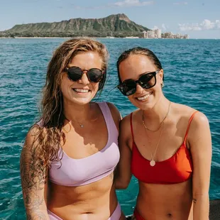 "Two girls enjoying a boat ride in Waikiki, Honolulu, ready for an epic snorkeling adventure - one of the best fun activities in Hawaii!"