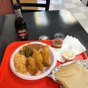 a plate of food and a bottle of beer