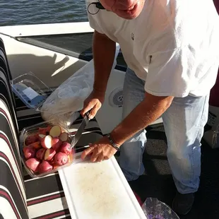 Bob, a member of the crew, cut up veggies, to throw to the pigs.