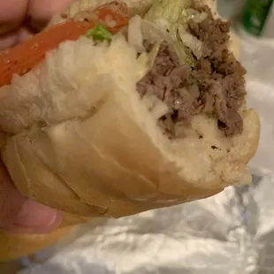 a hand holding a sandwich