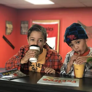 two children drinking coffee