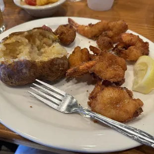 Fried shrimp, baked potato and veg (in weird tomato base)