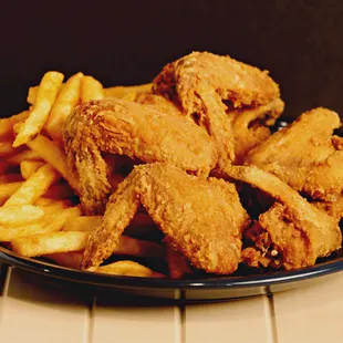 a plate of fried chicken and french fries