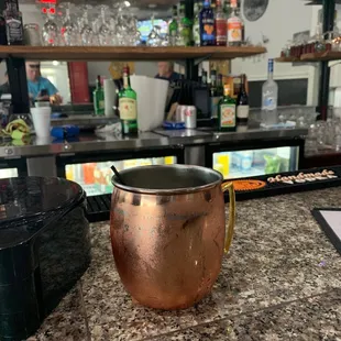a copper mug on the bar