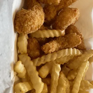 a basket of fried fish and fries