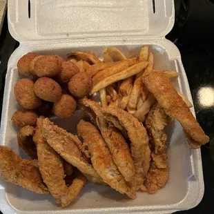 Filet of Perch fries and hush puppies. (I added my own Cajun seasoning out of habit, but you don't need to because it's good as is)