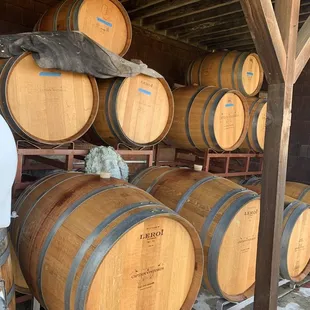 a man standing in front of barrels