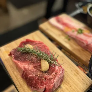 two steaks on cutting boards