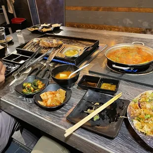 From right to left: Bimbap rice, spicy tonkotsu soup, kimchi and cucumbers, miso beef (drool) on the grill with garlic butter.