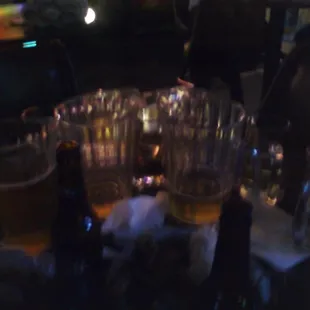 a table full of beer glasses