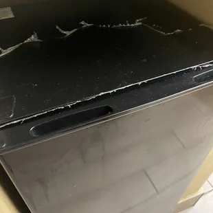 Fridge is old and looks damaged.