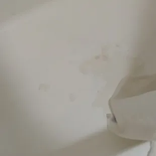 Chipping tub with WET shower curtain and mold on the ceiling!