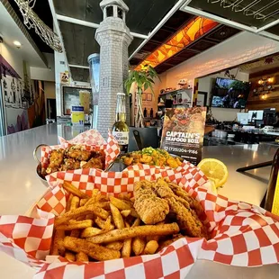Chicken tender with cajun fries, soy garlic wings, and house signature cajun seafood fried rice