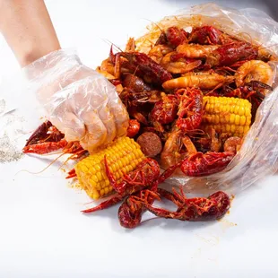 Crawfish, shrimp, corn, and sausage boil mix doused in Captain&apos;s Mix sauce