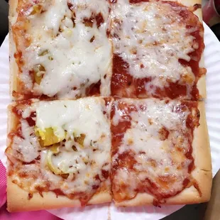 a pizza on a paper plate