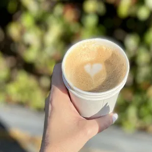 a hand holding a cup of coffee