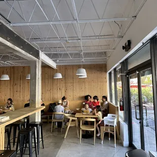 people sitting at tables in a restaurant